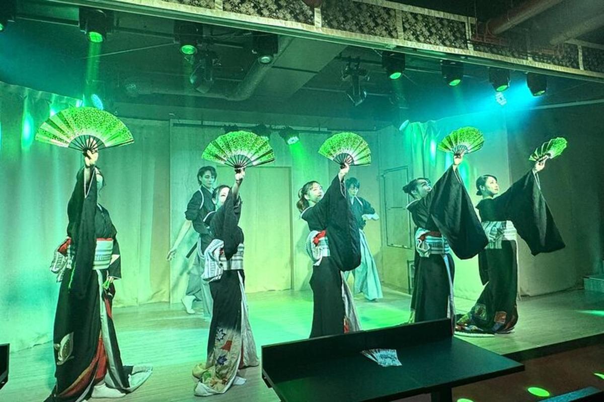 a group of people on a stage holding umbrellas