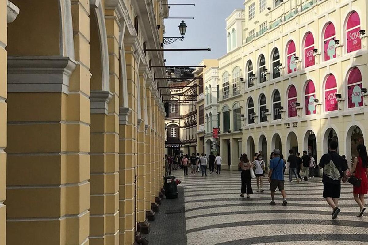 a group of people walking down a street with buildings