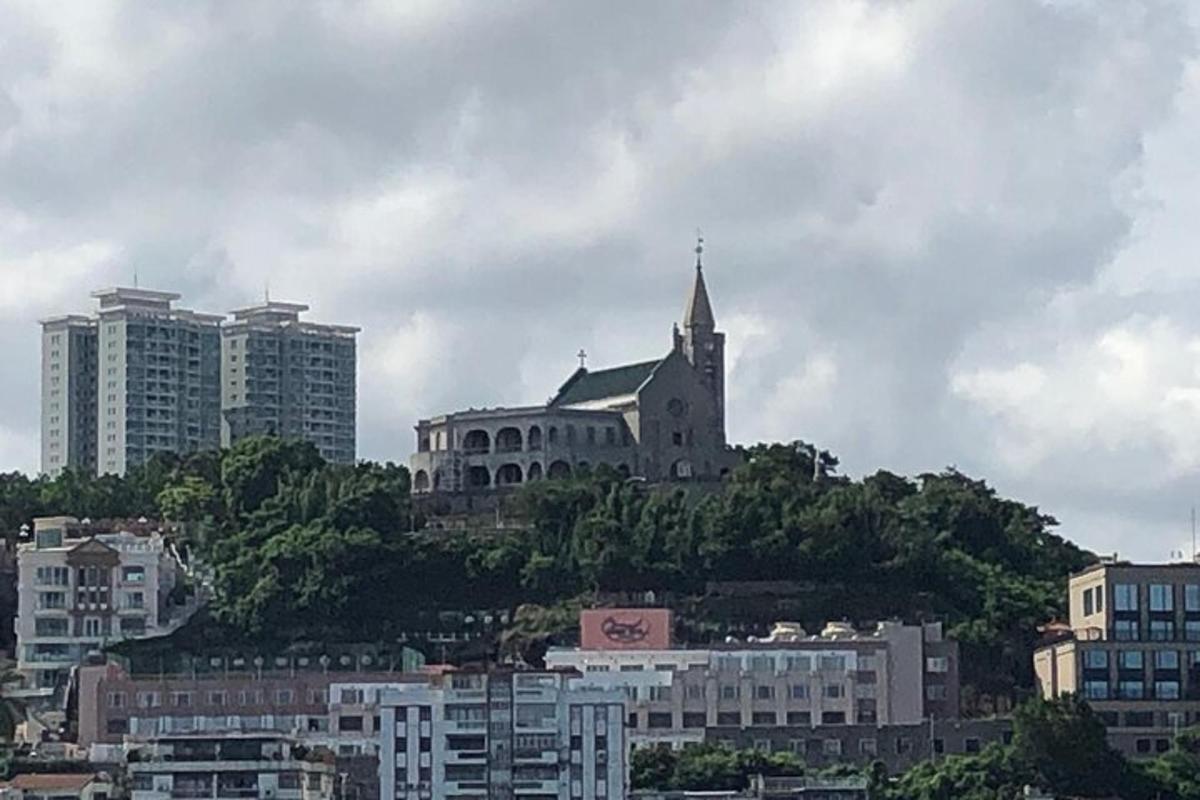 a church on top of a hill in a city