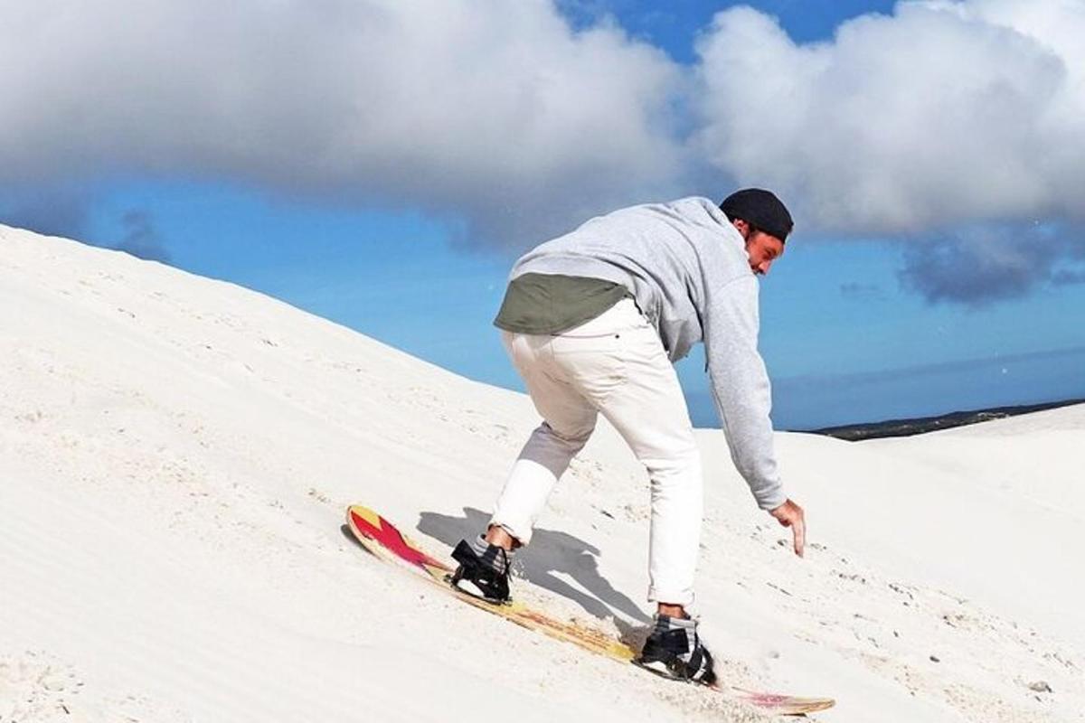 un home baixant amb una taula de snowboard per un pendent cobert de neu
