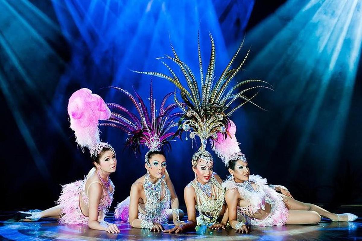 four women in mermaid costumes sitting in front of a pineapple