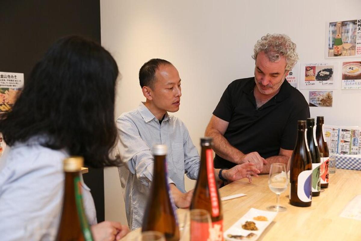 a group of people standing around a table with wine bottles
