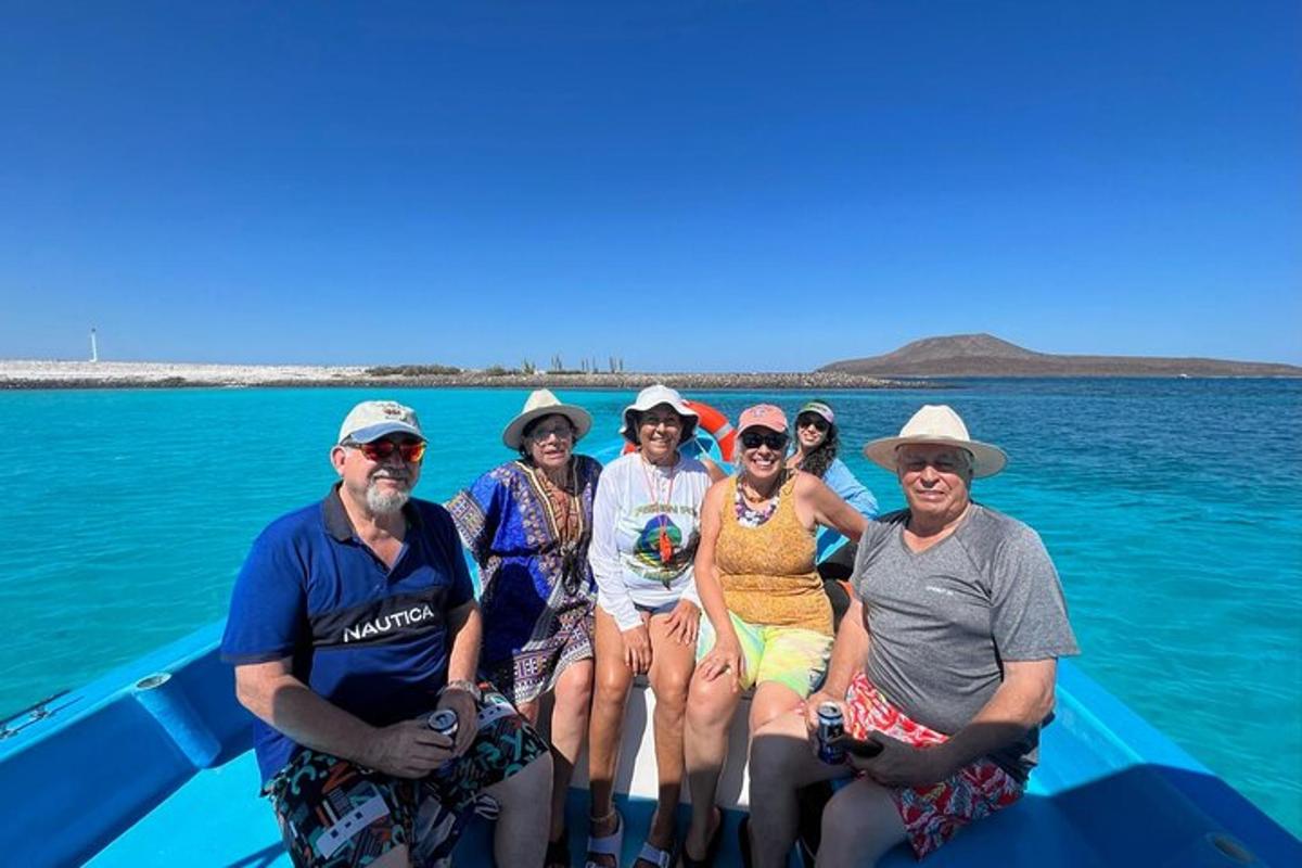 a group of people sitting on a boat in the water