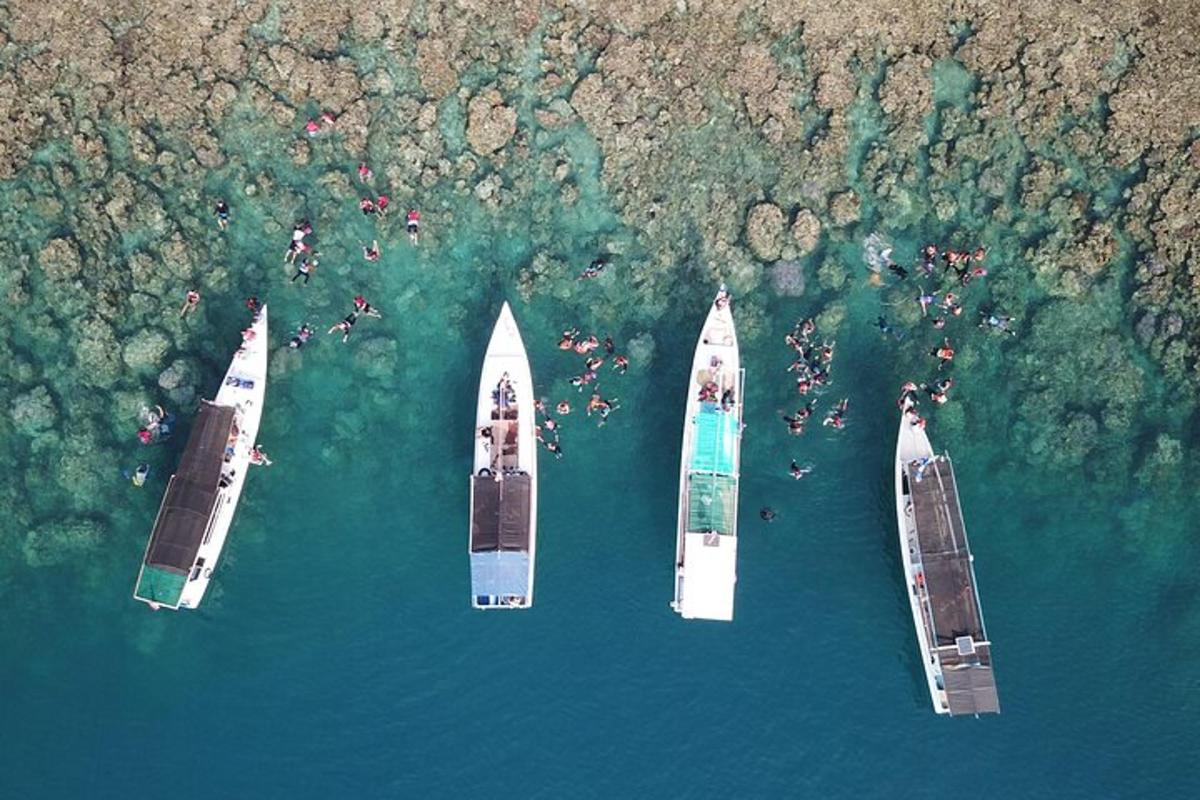 three boats floating in the water in the ocean