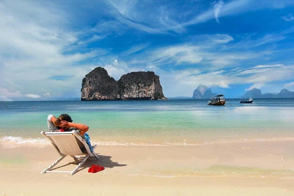 a man sitting in a chair on a beach