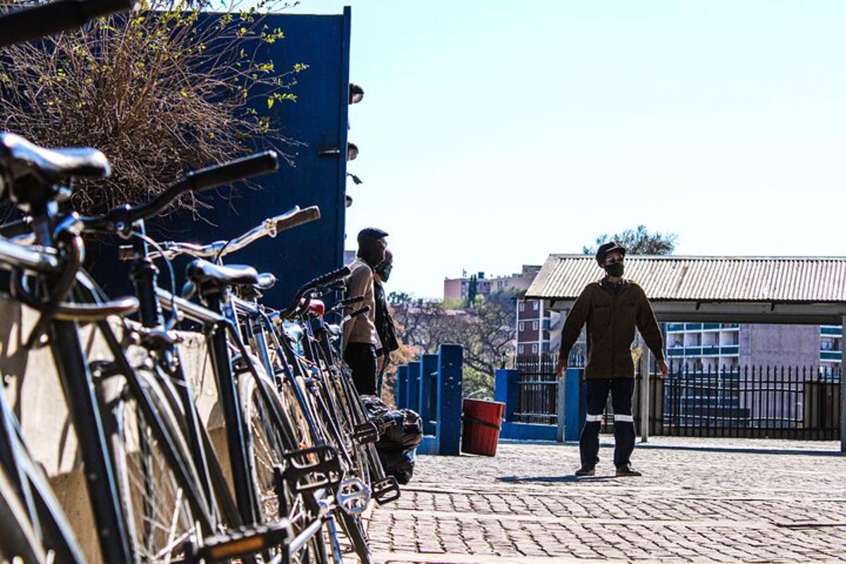 two men standing next to a bunch of bikes