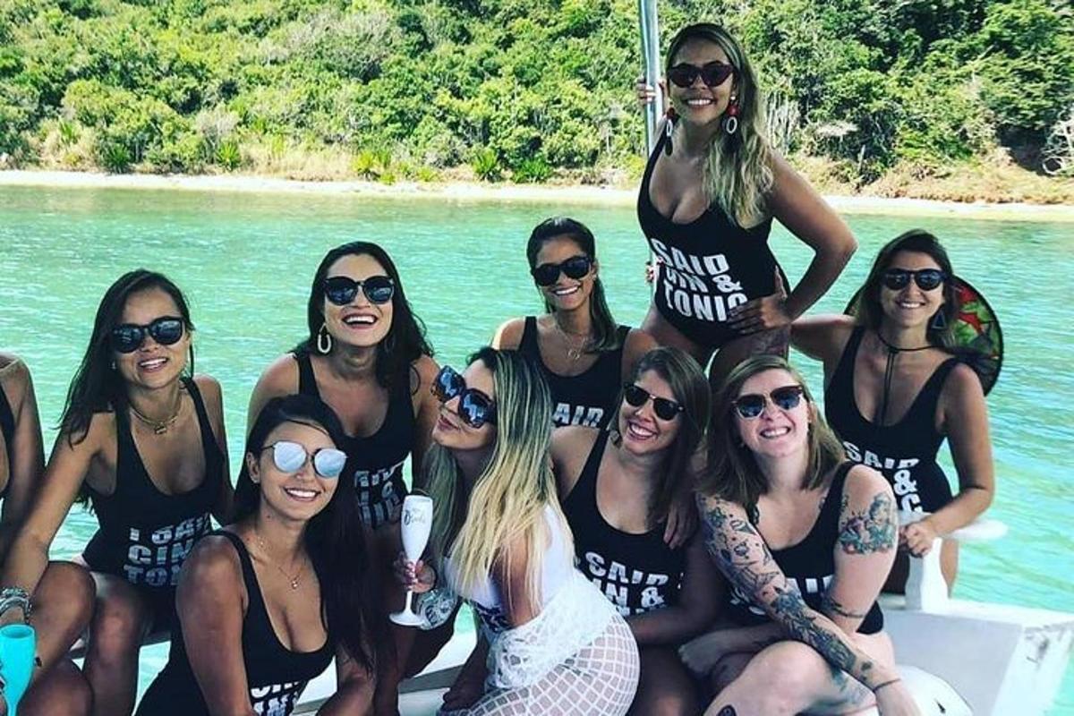 a group of women sitting on a boat in the water