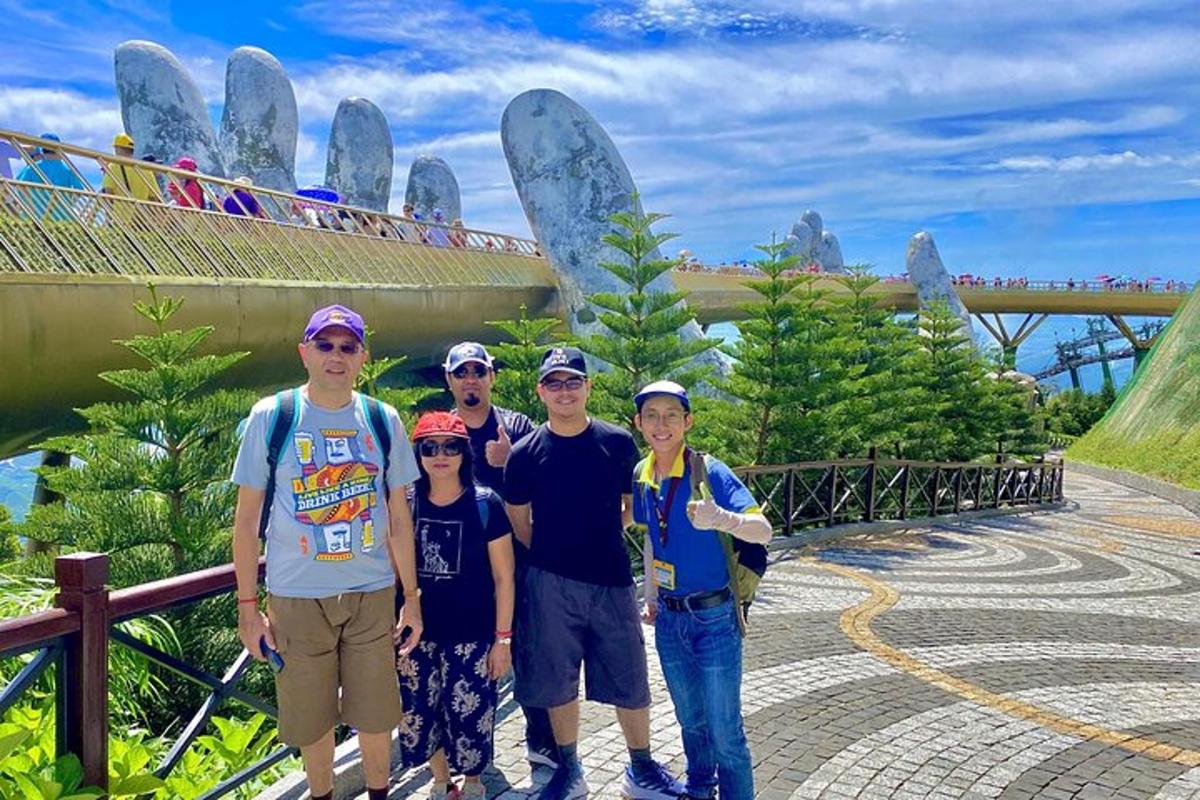 a family posing for a picture in front of a bridge