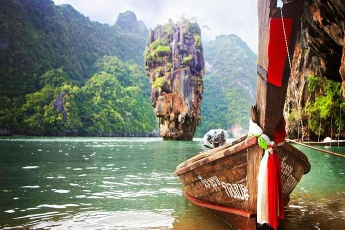 a boat in the water with mountains in the background