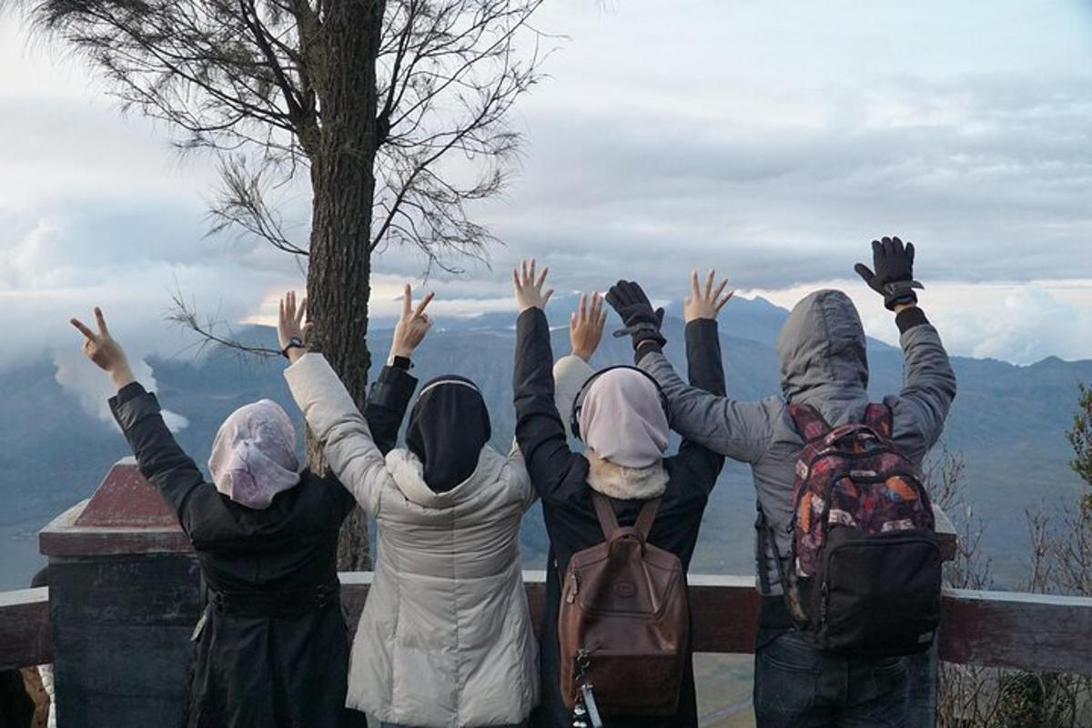 a group of people standing with their hands in the air