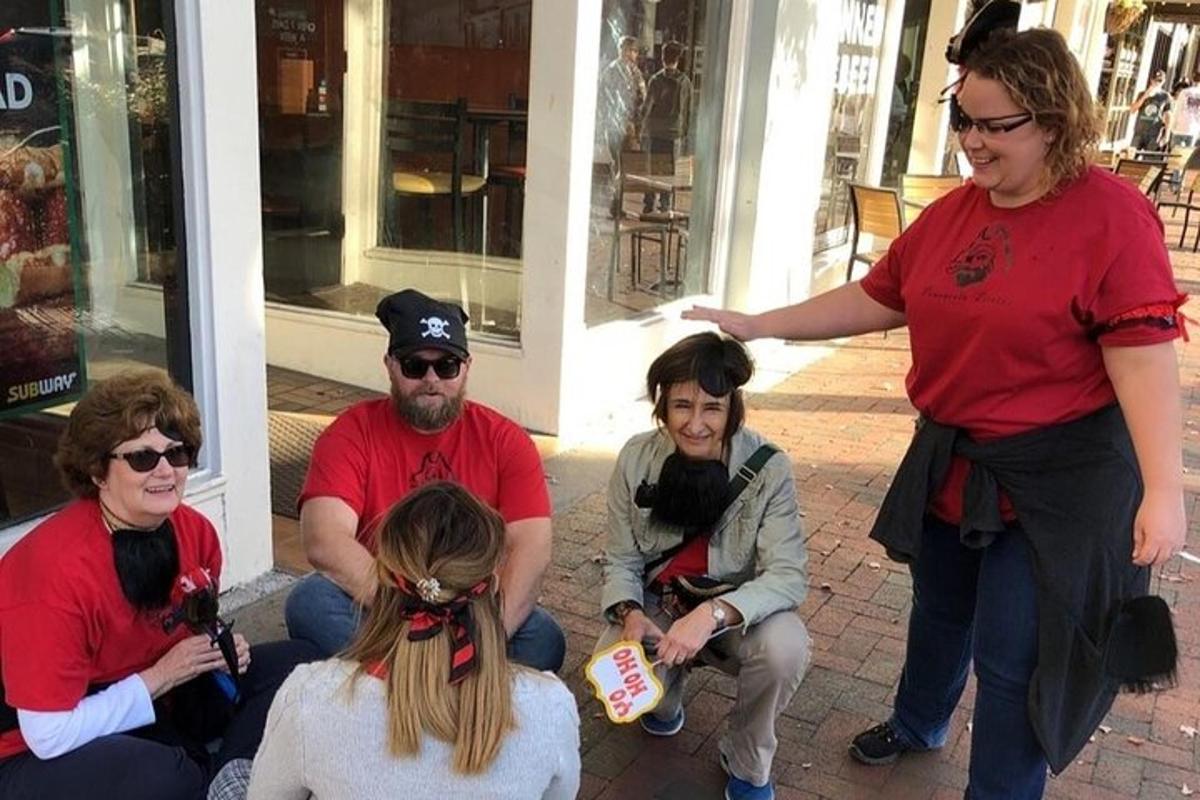 a group of people sitting on the sidewalk