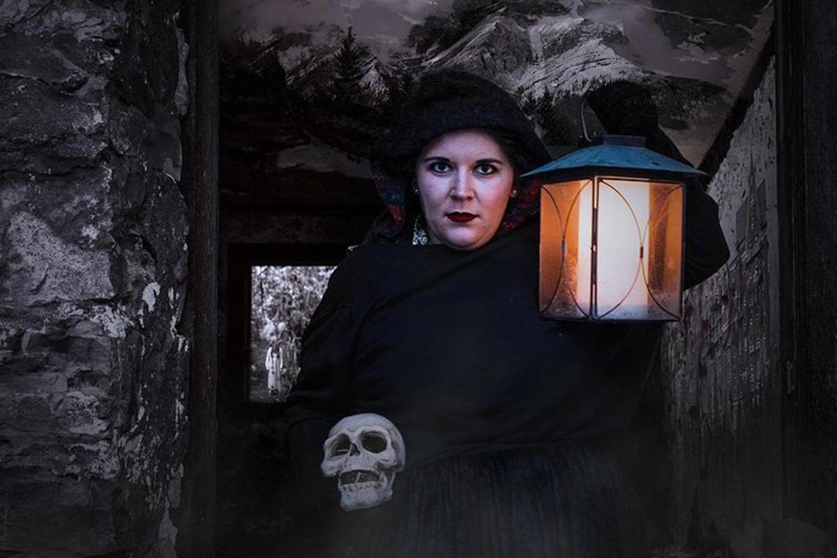 a woman standing in a room with a skull