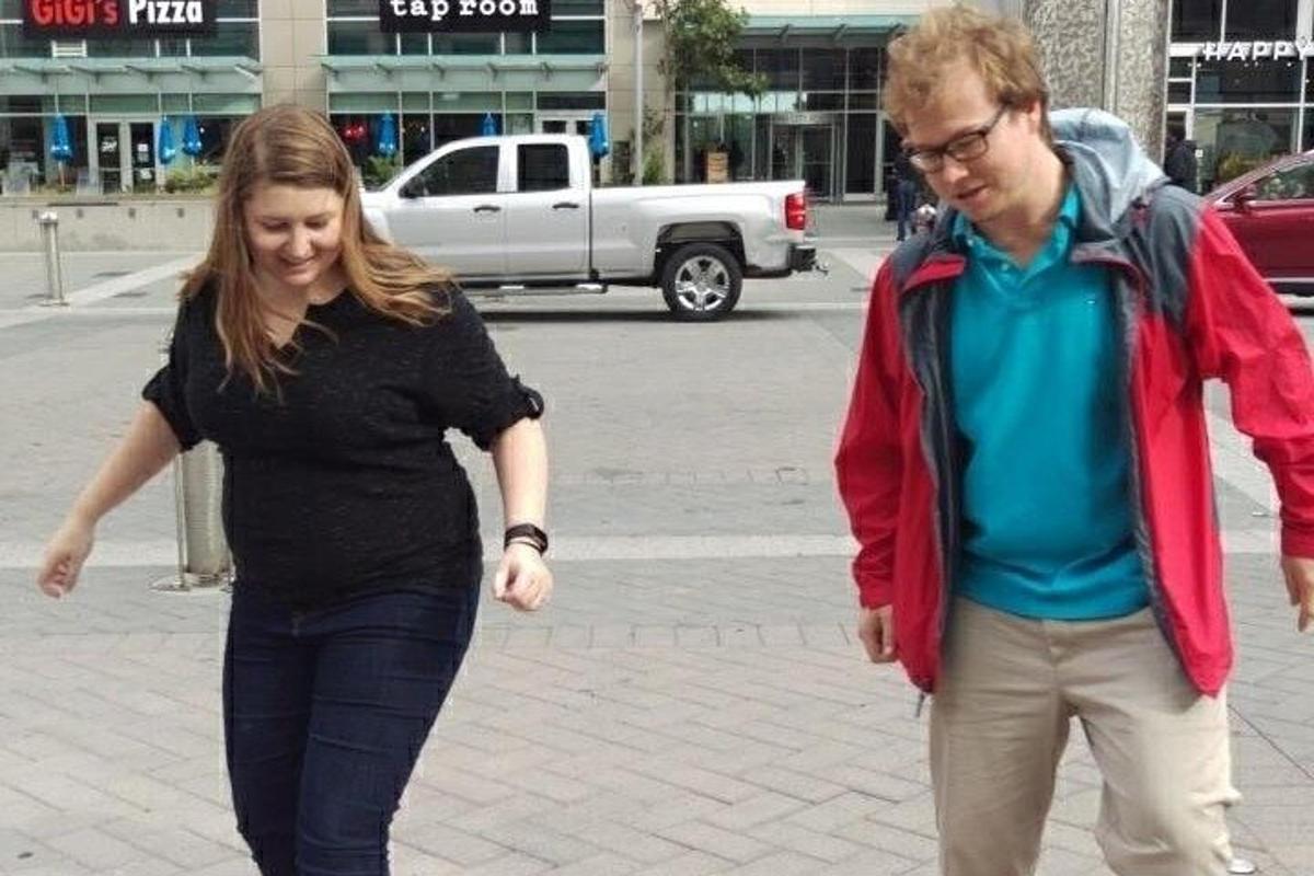a man and a woman walking down a street