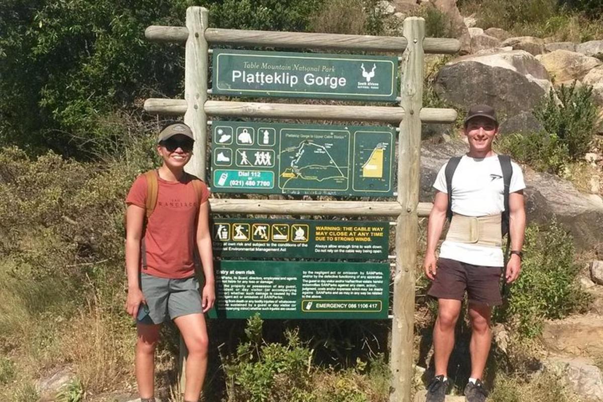 two people standing in front of a sign