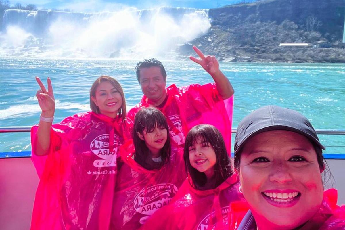 a group of people wearing pink shirts on a boat