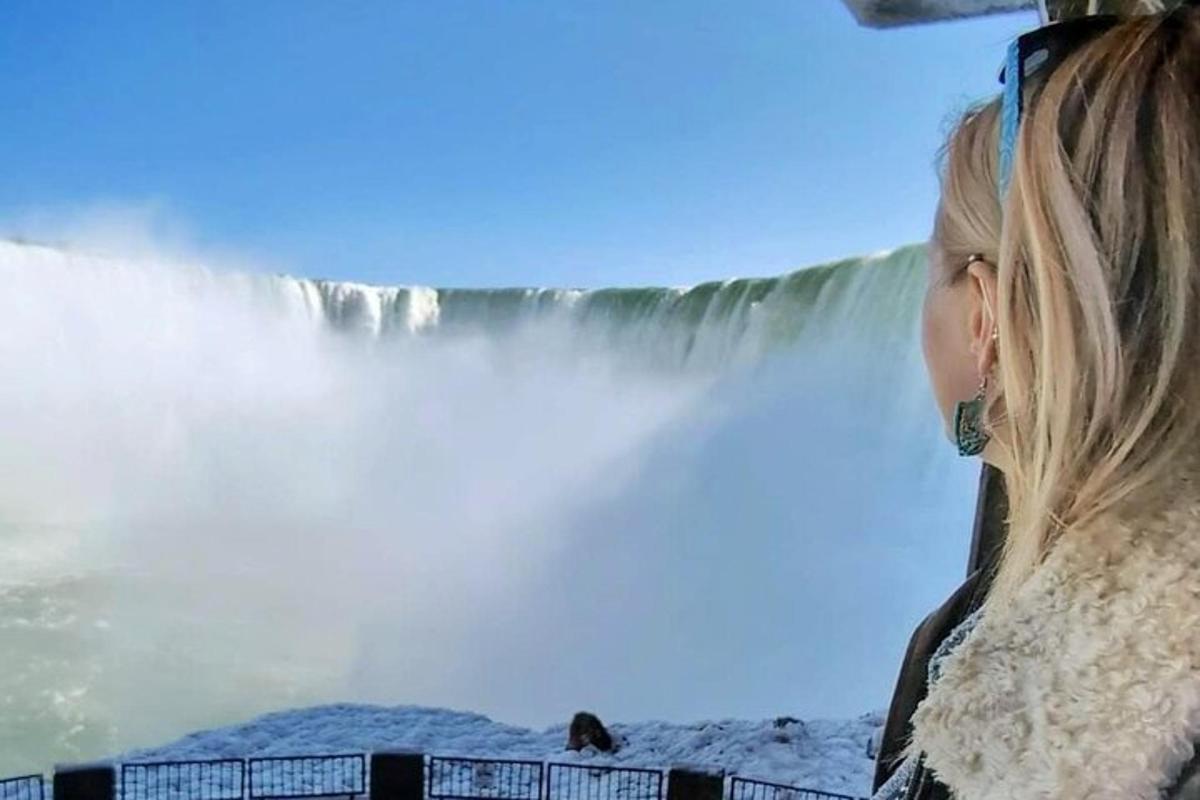 a woman standing in front of a waterfall