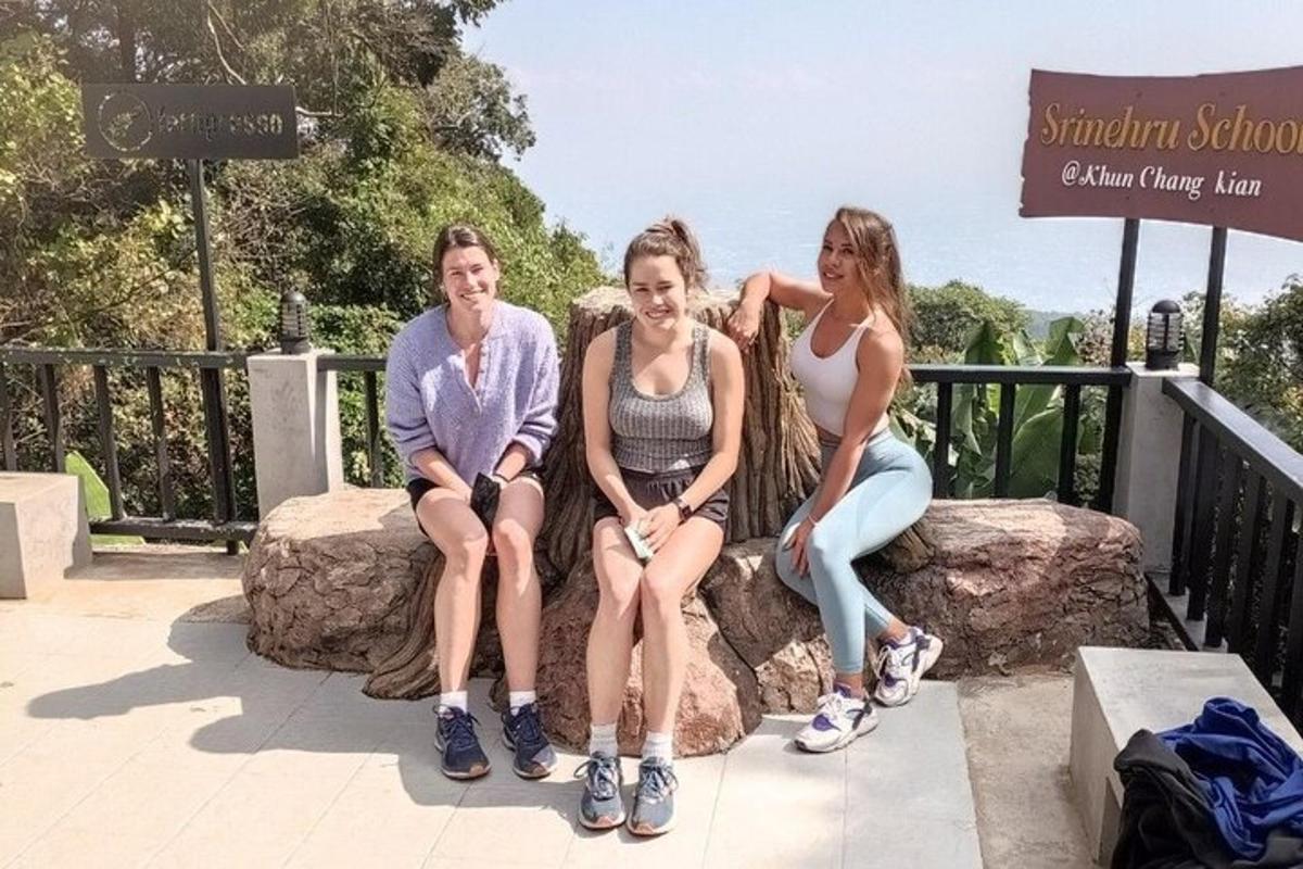tres mujeres sentadas en un tocón de árbol