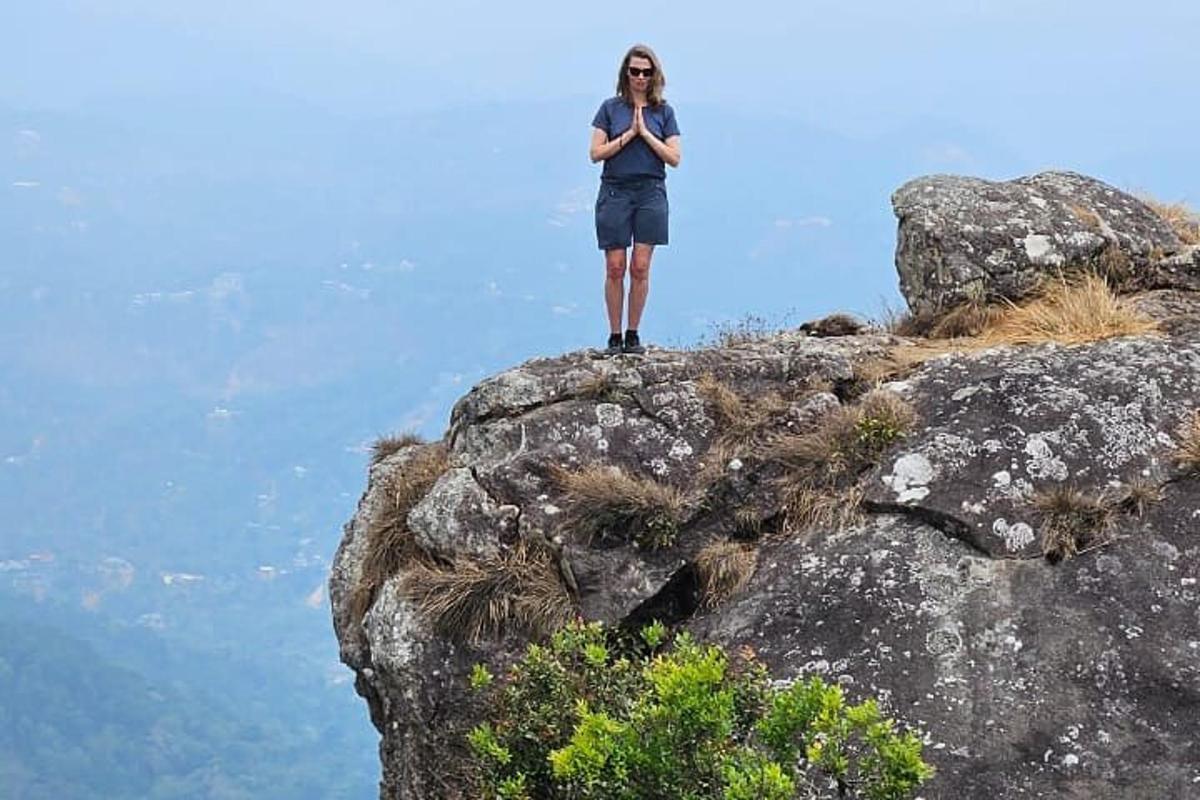 a man standing on the top of a mountain