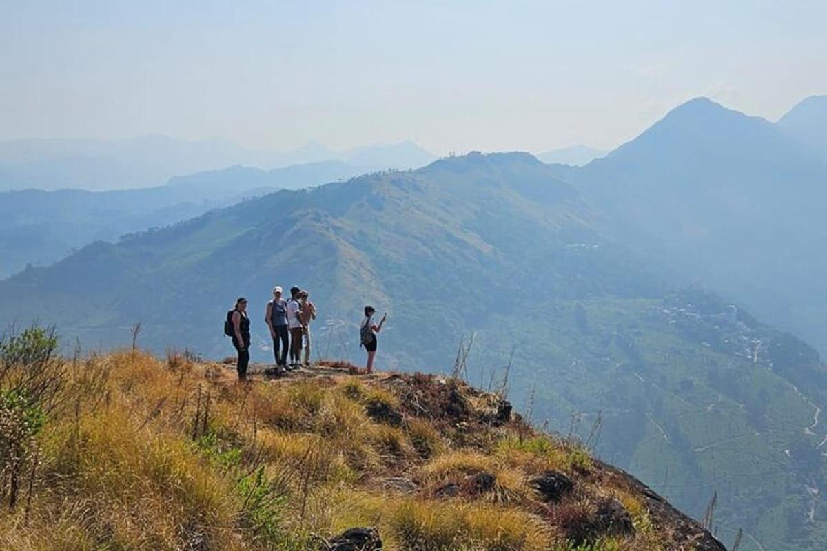 a group of people standing on top of a mountain