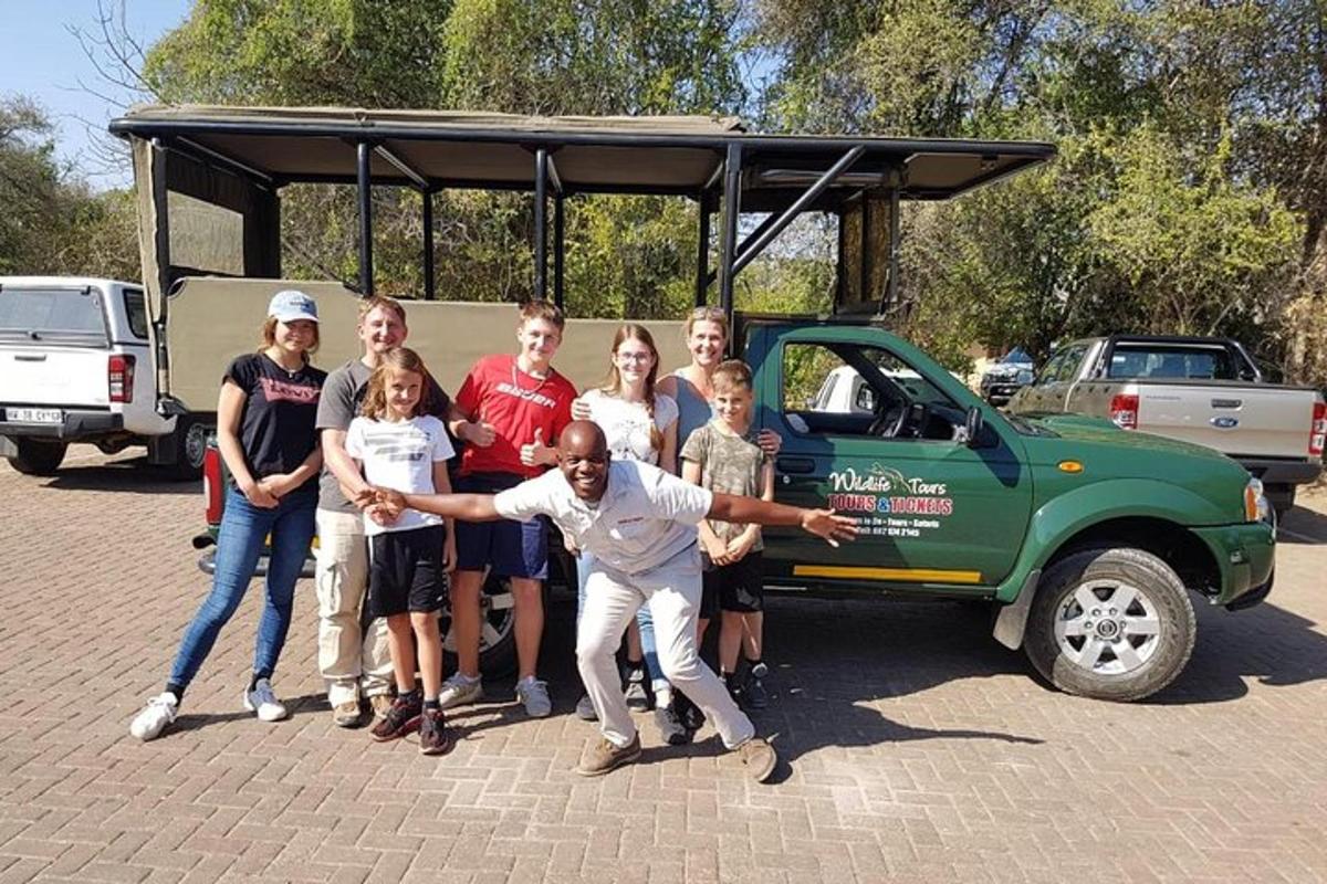 a group of people standing in front of a car