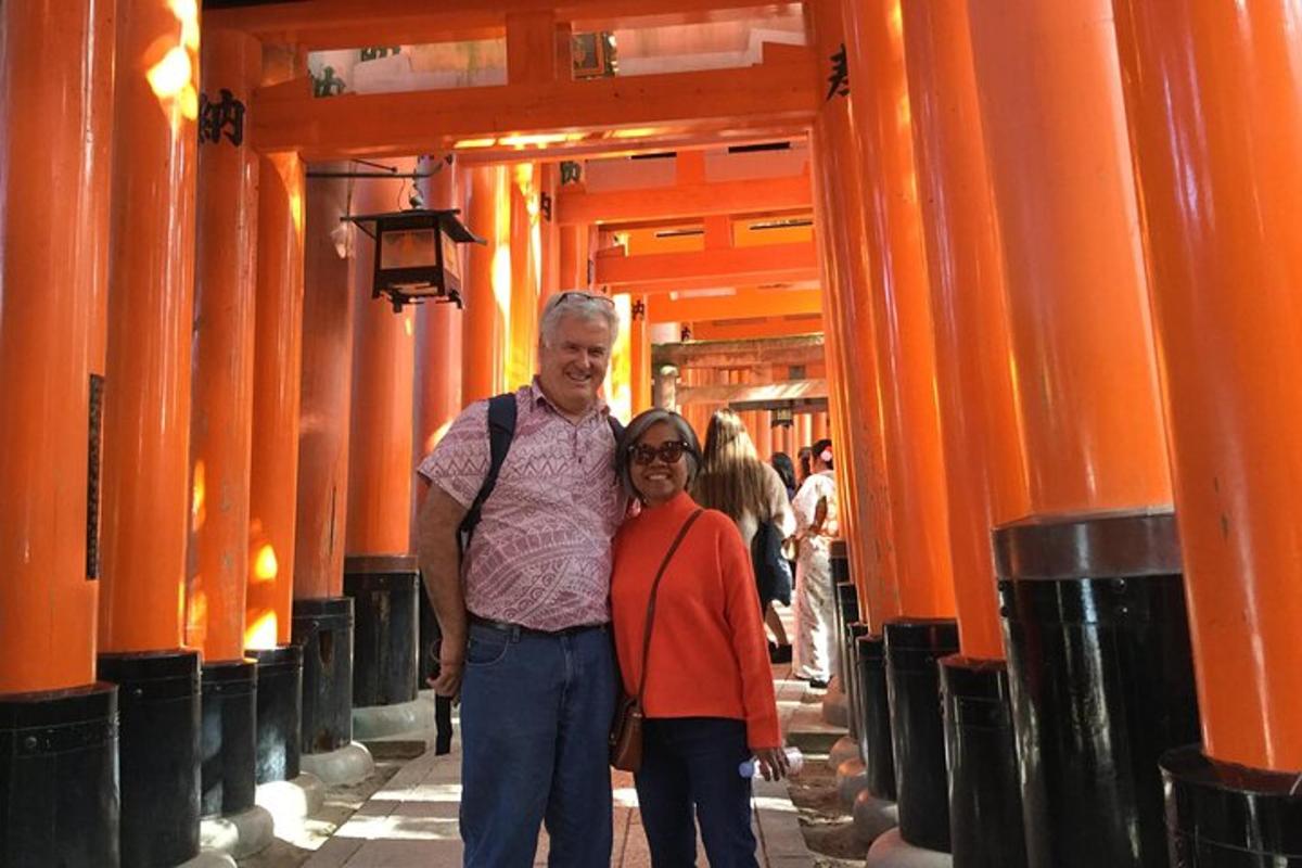 a man and a woman standing in an alley with orange columns