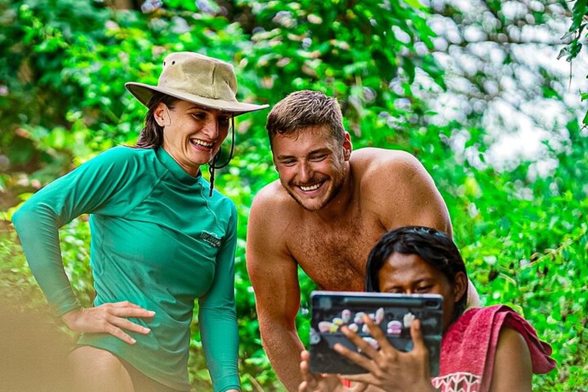 a man and a woman are looking at a tablet