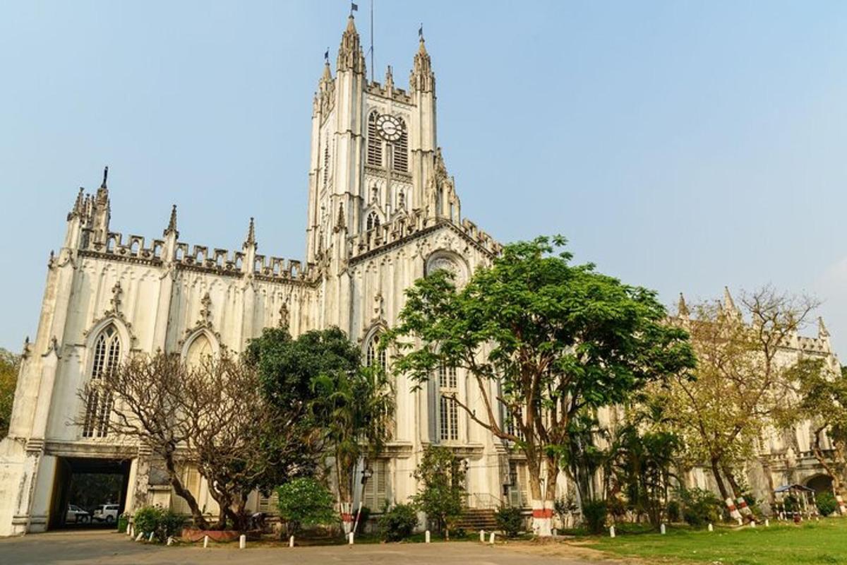 a large cathedral with a clock tower and trees