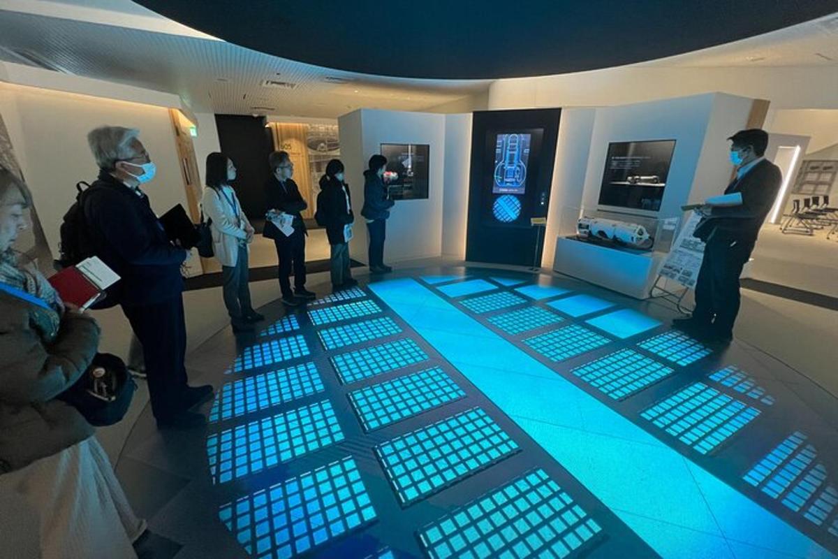 a group of people standing around a room with blue lights