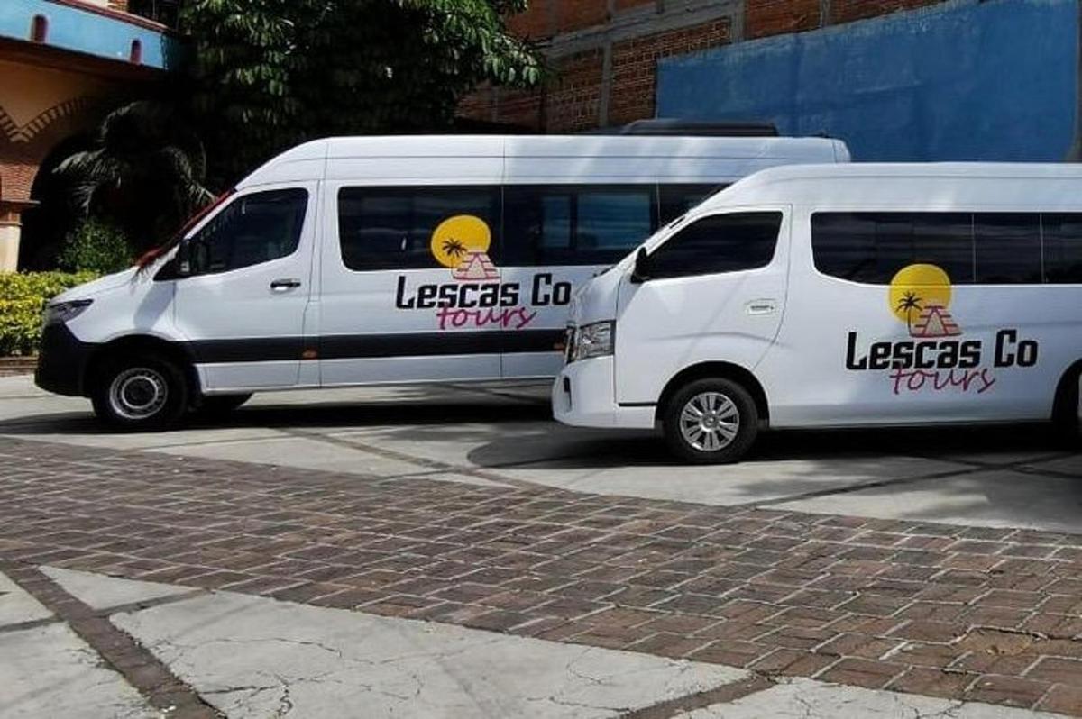 two white vans parked in a parking lot