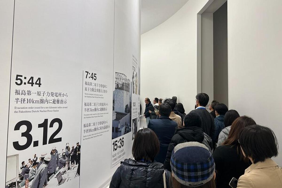 a group of people standing in a room looking at a poster