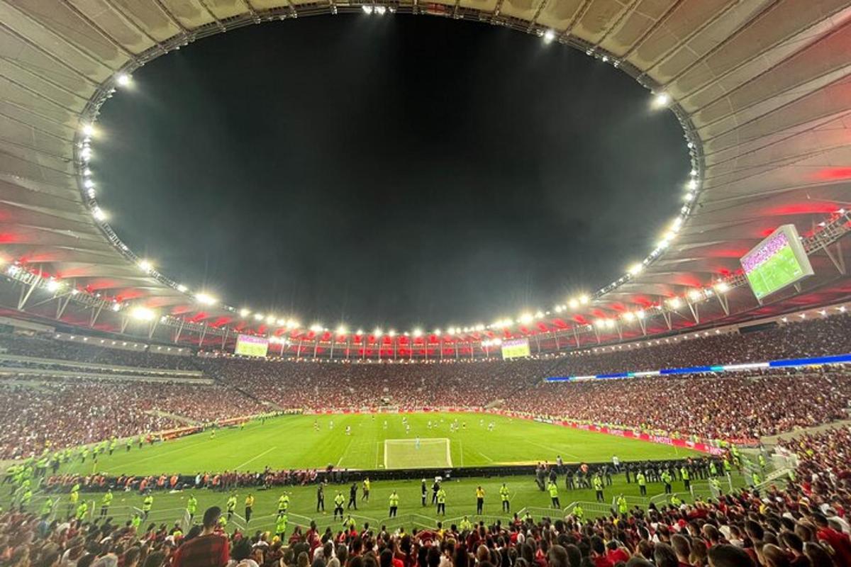 a crowd of people watching a soccer game in a stadium