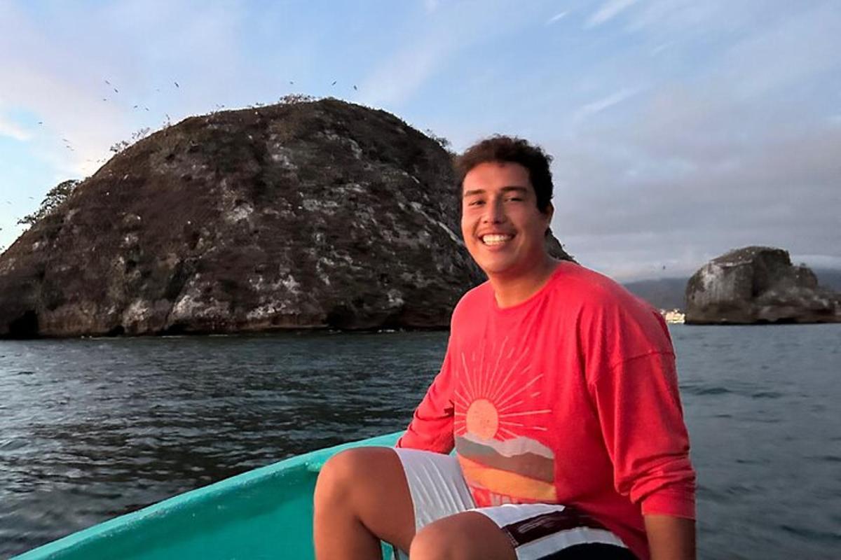 a man sitting on a boat in the water