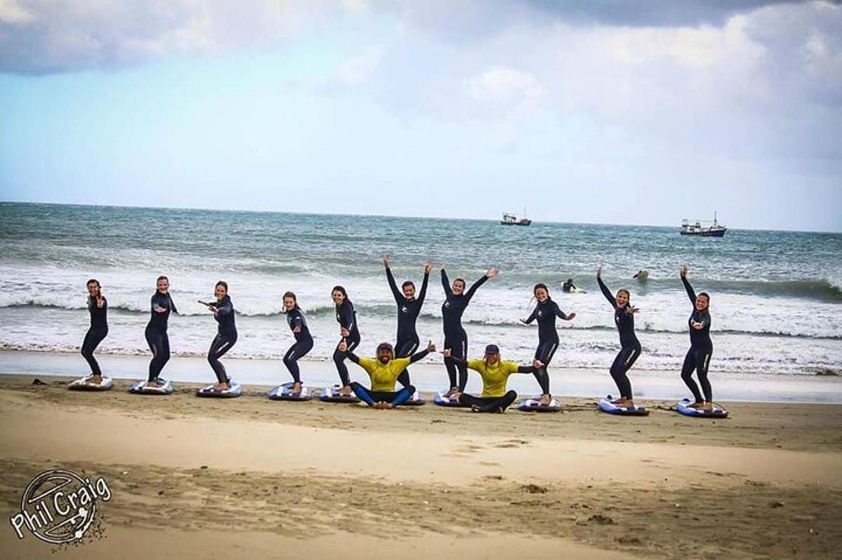 a group of people on surfboards on the beach