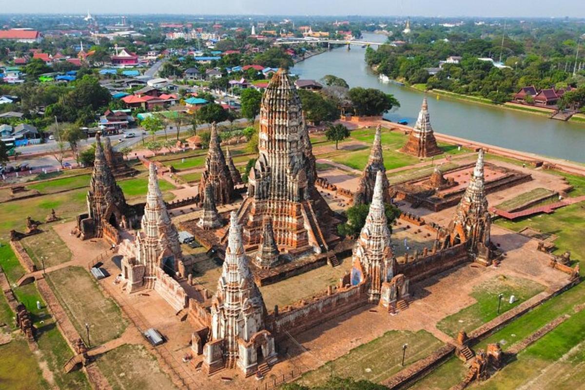 an aerial view of a temple near a river