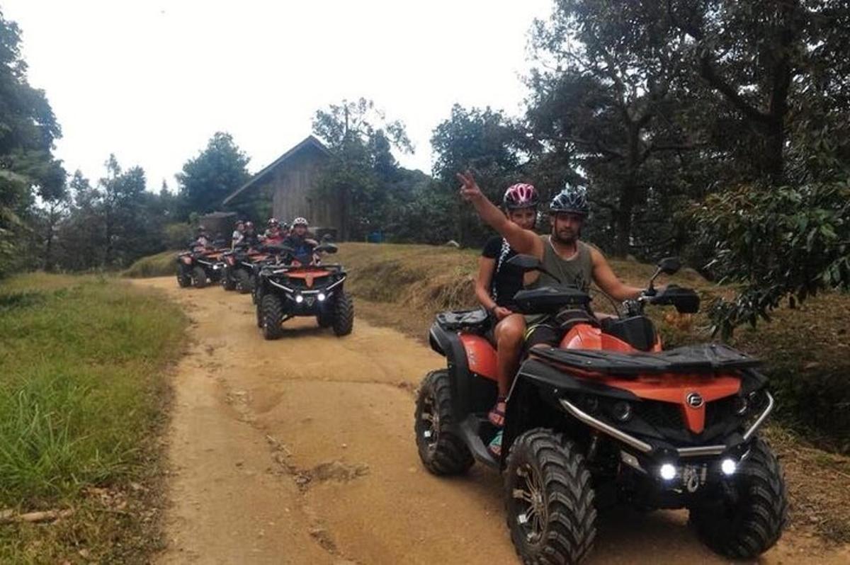 un gruppo di persone che guidano quad lungo una strada sterrata