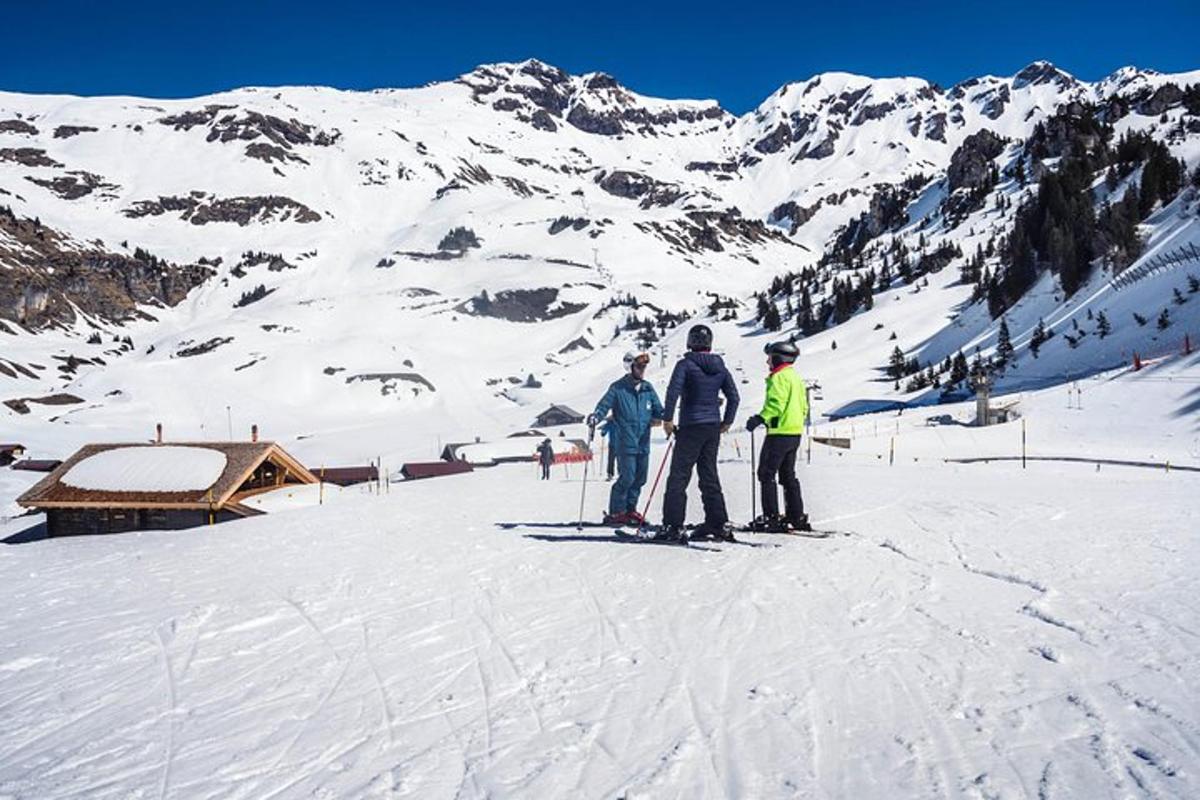 three people on skis on a snow covered mountain