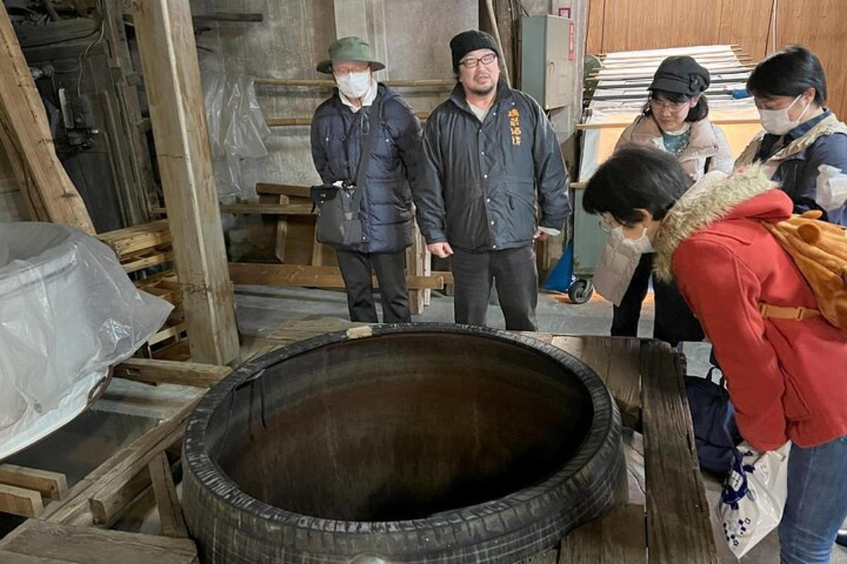 a group of people standing around a large tire