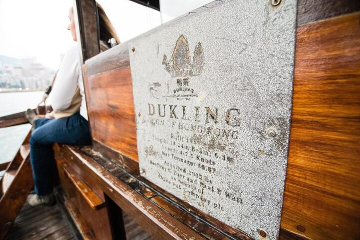a person sitting on a wooden bench on a boat