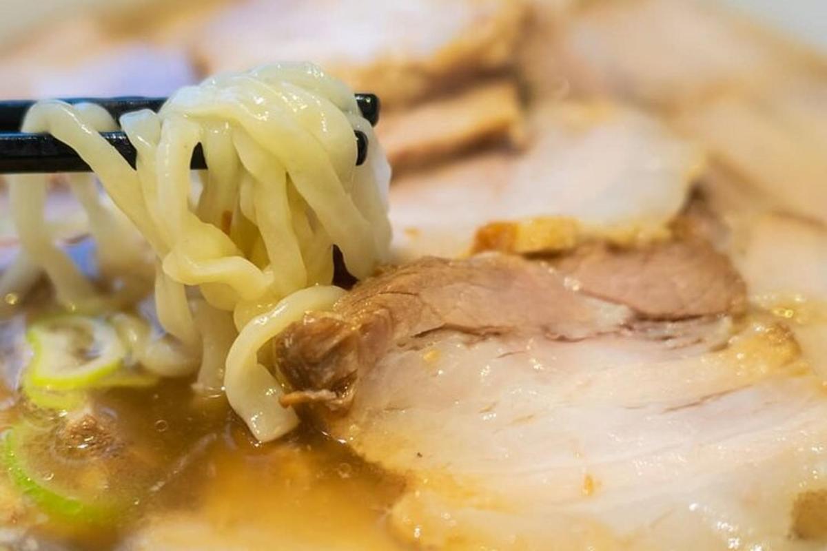 a plate of food with noodles and meat and cheese