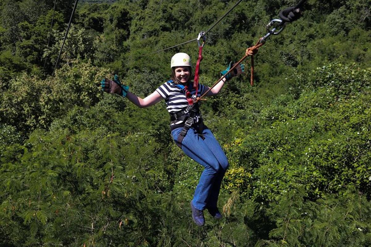 a man flying through the air on a zip line