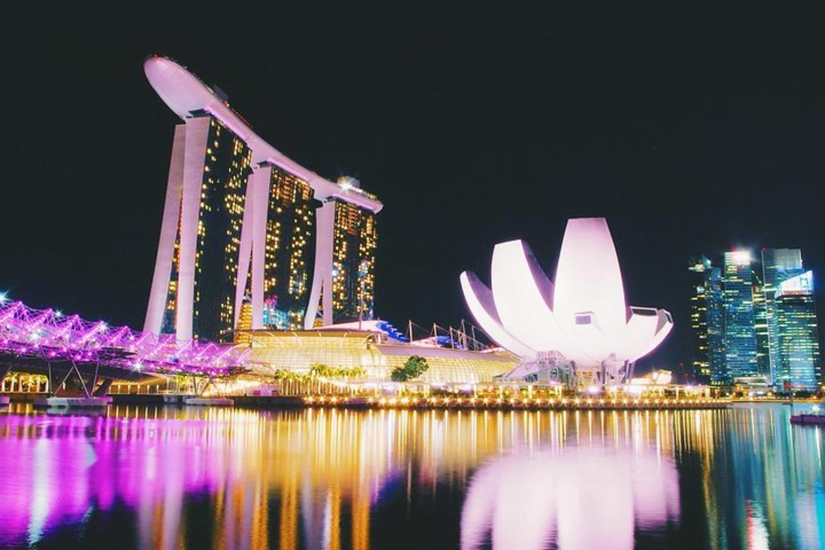 a night view of a city with buildings and the water