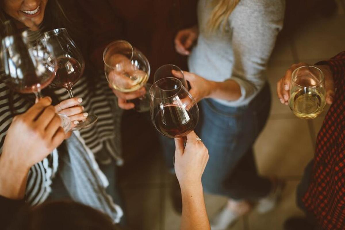 a group of people holding up wine glasses