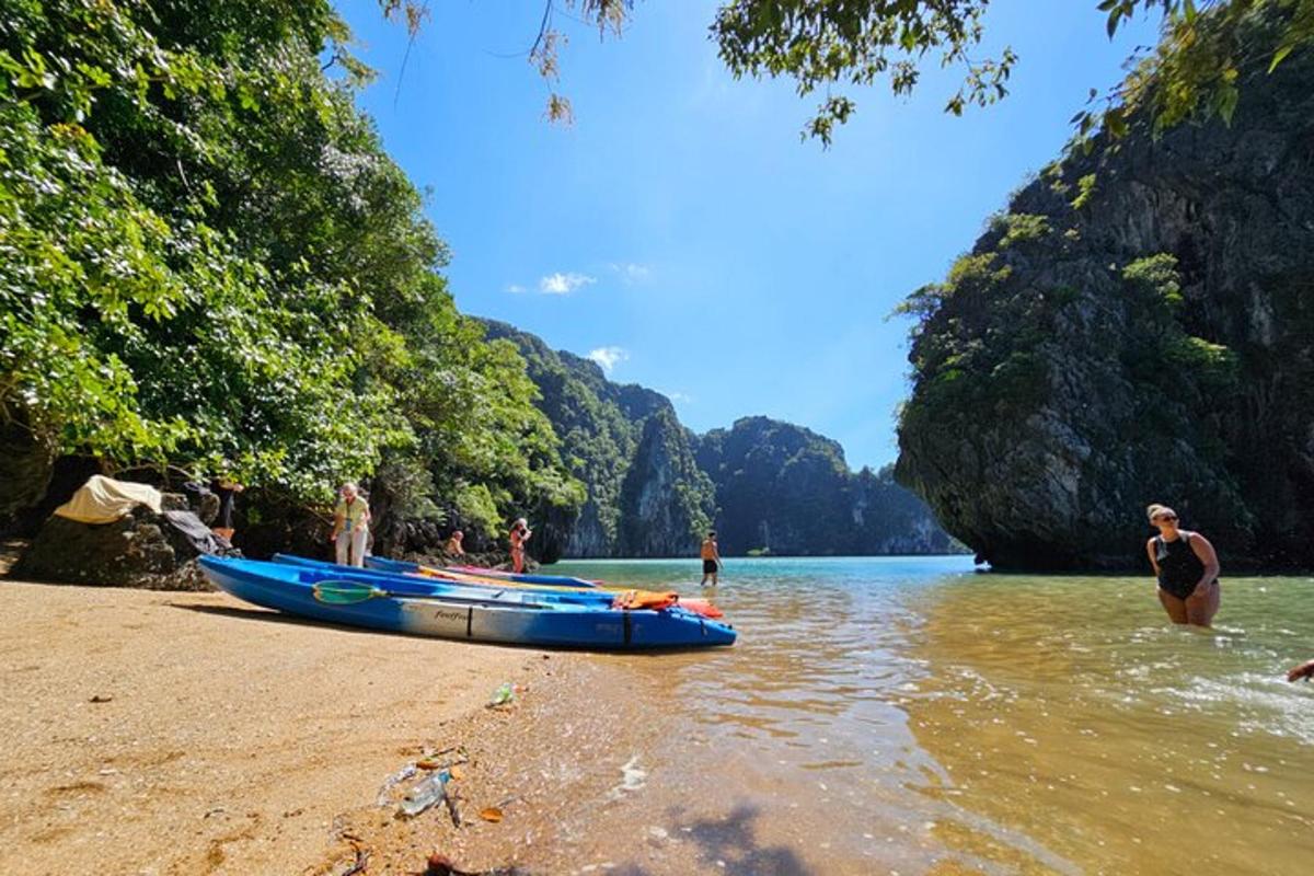 a person standing on a beach with a blue boat