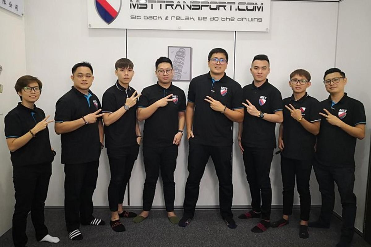 a group of men in black t shirts posing for a picture