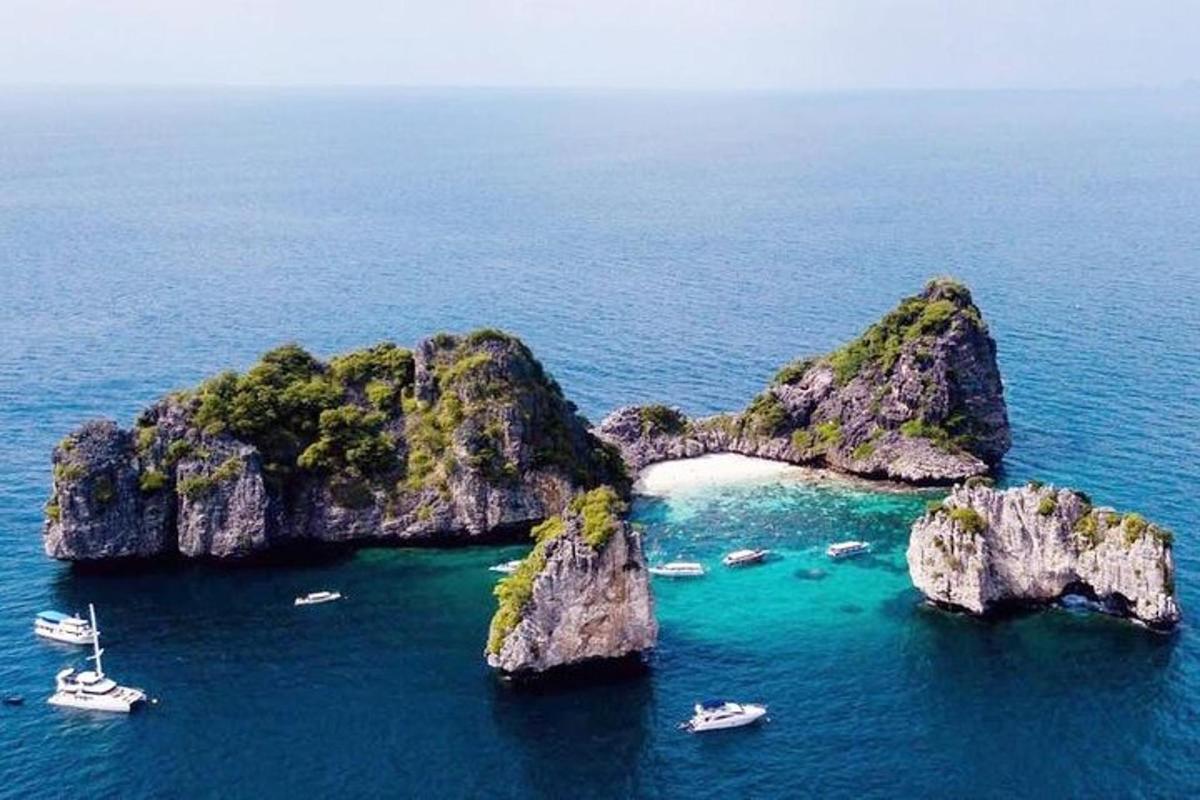 an island in the ocean with boats in the water