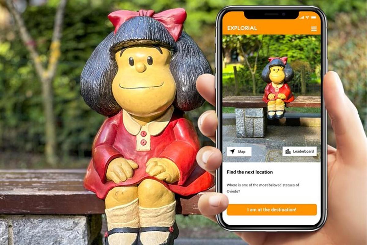 a person holding up a cell phone to take a picture of a toy