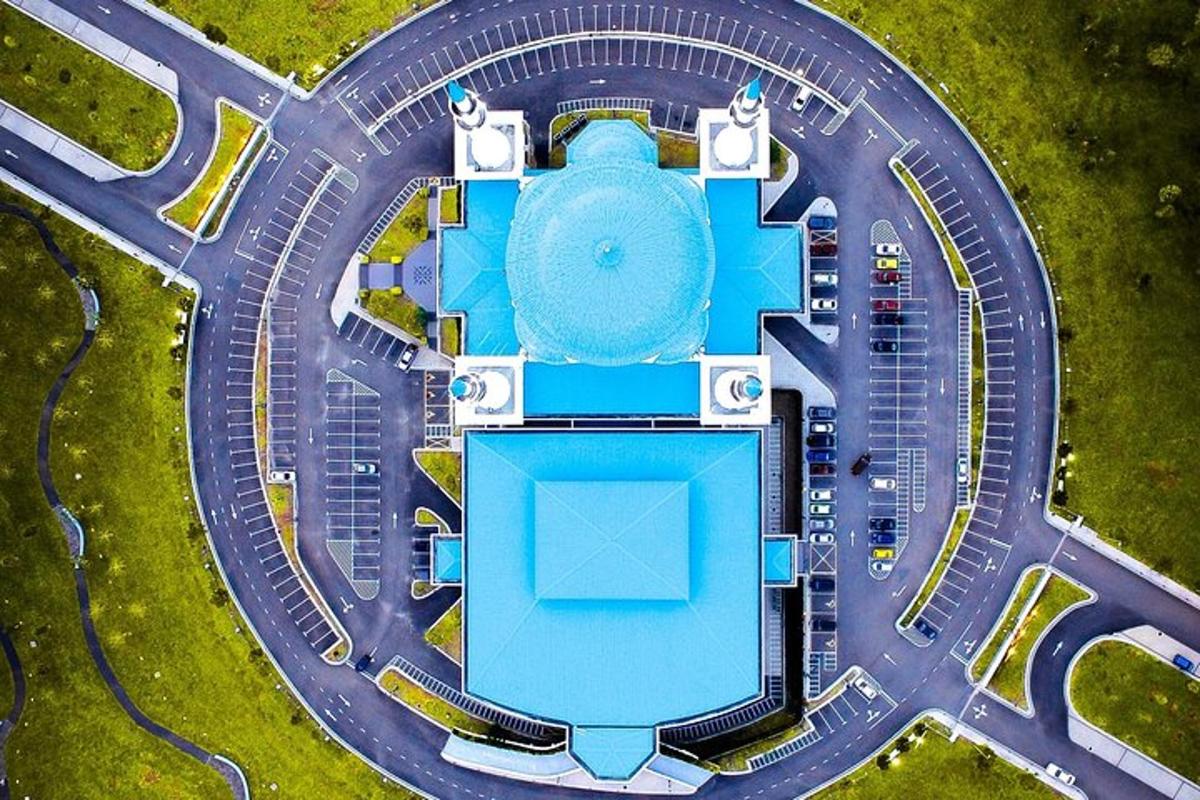 an overhead view of a building with a pool