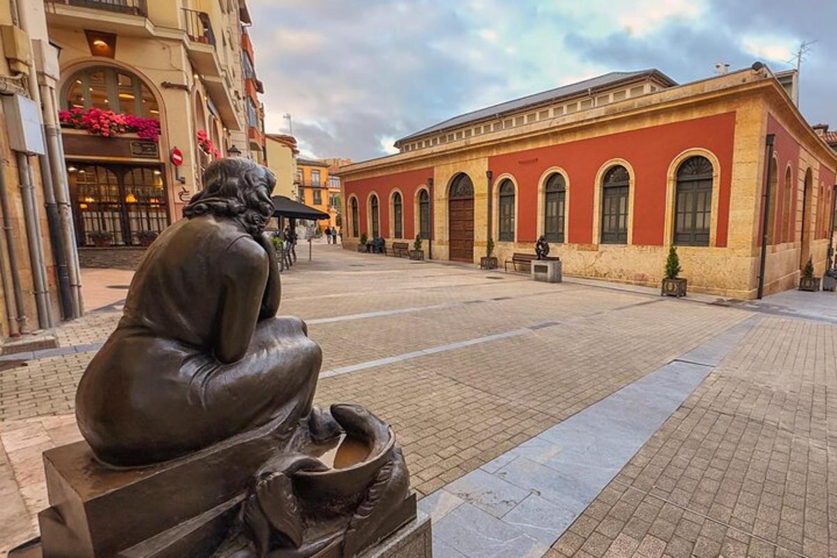 a statue of a woman sitting on a bench in a street