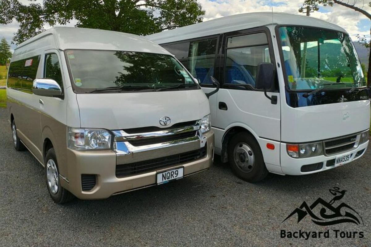 a white van parked next to a white bus
