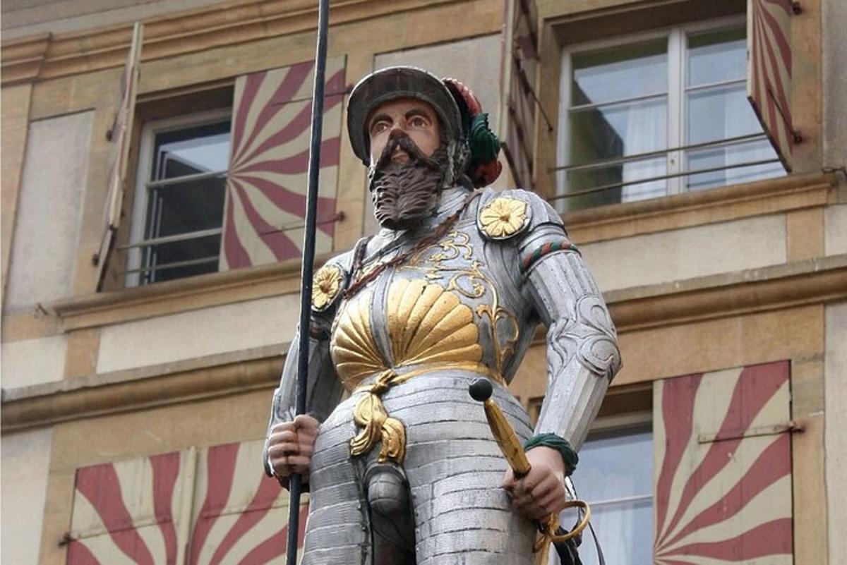 a statue of a man in armor holding a flag
